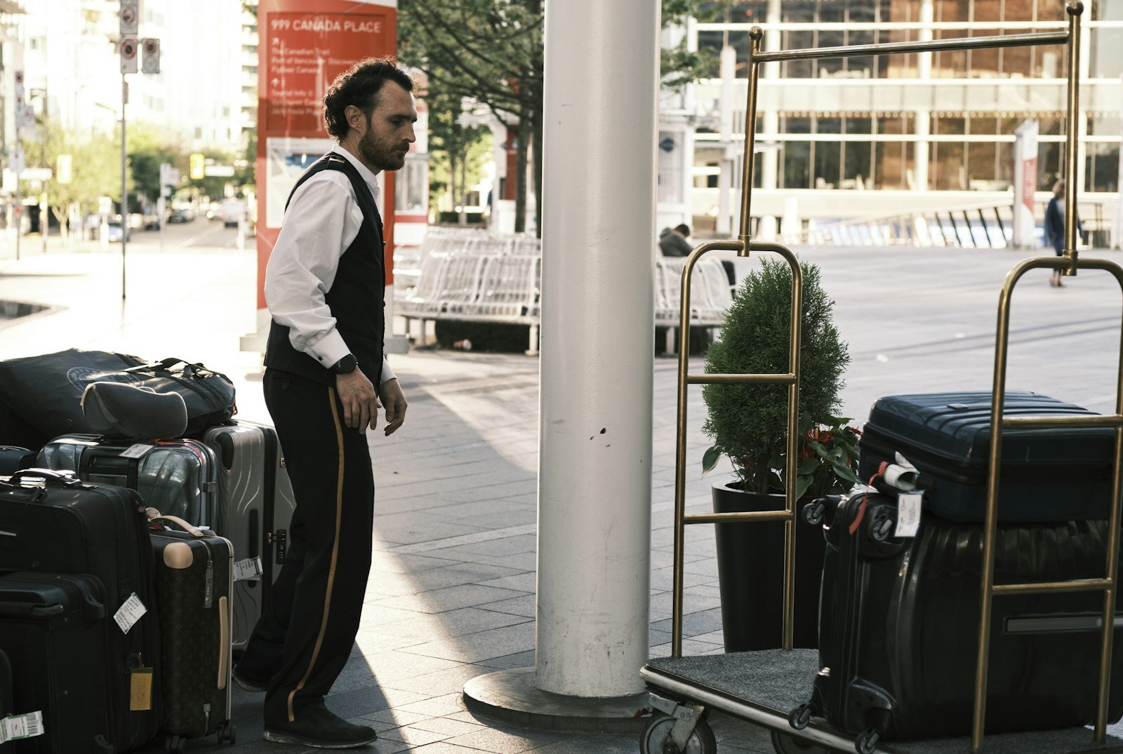 a man standing next to a pile of luggage